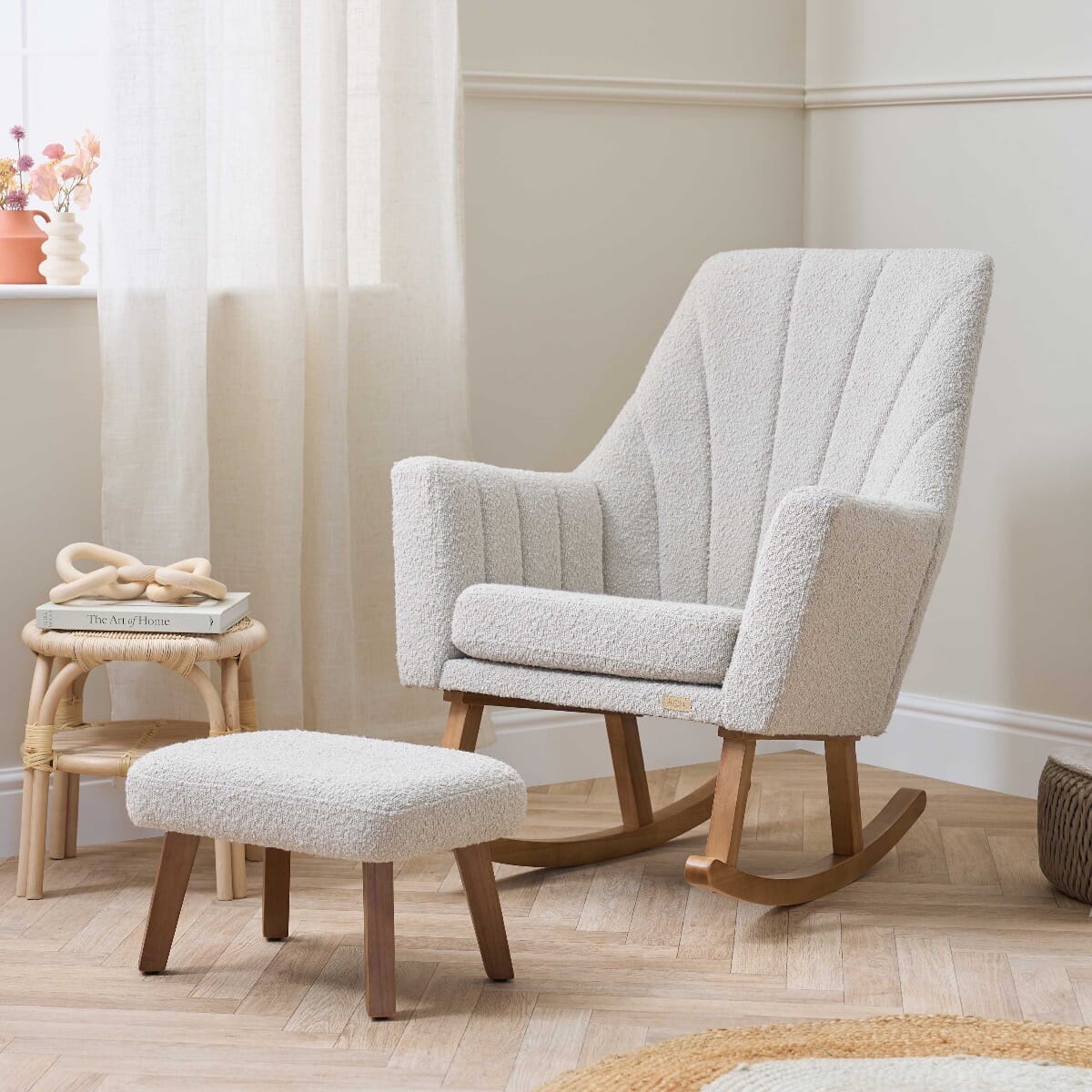 Nursery room view of the Jonah Luxe rocking chair and footstool in boucle mushroom, paired with soft-toned furniture and subtle styling