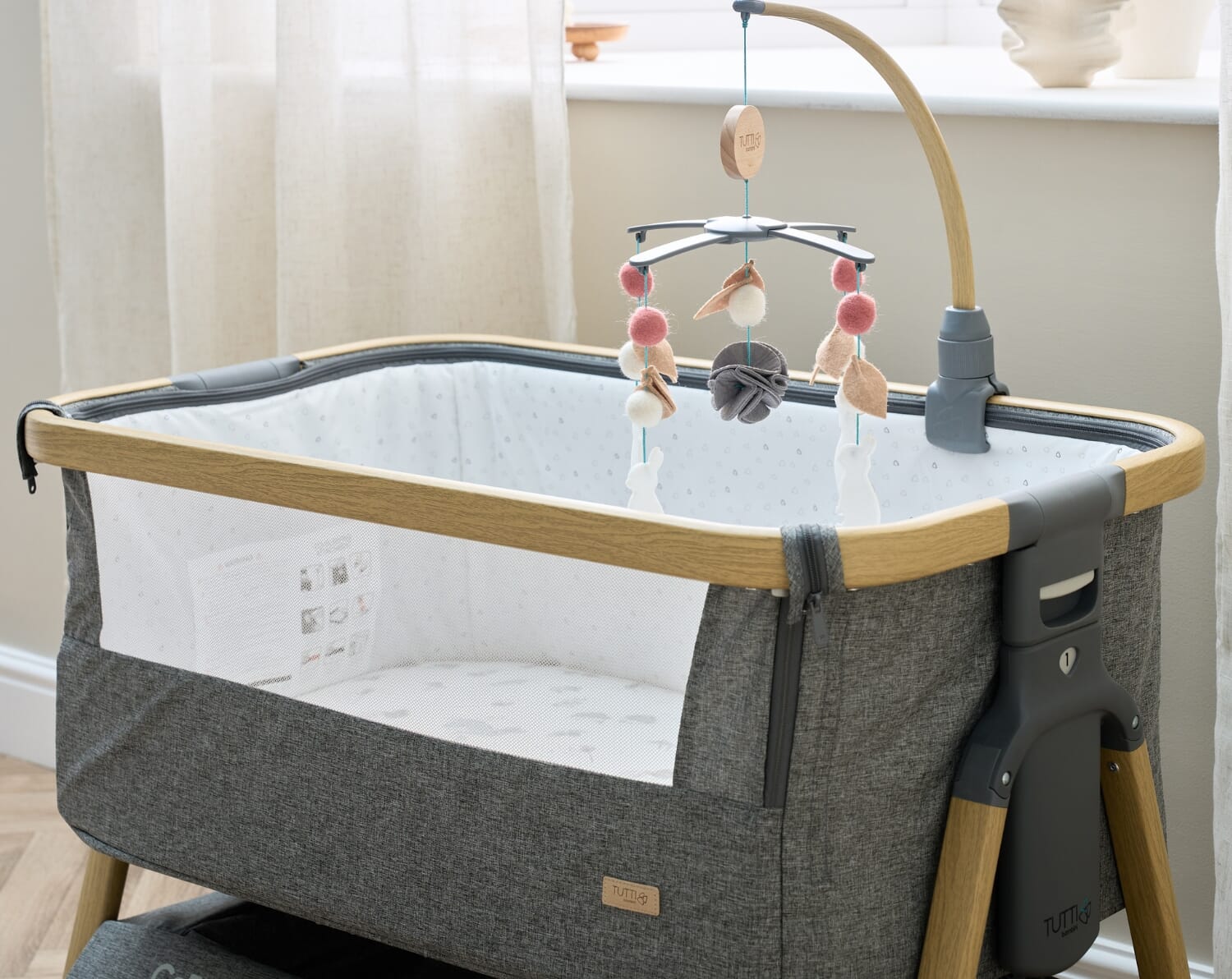 CoZee 2-in-1 Crib Oak & Charcoal – Features overhead mobile with soft textures to support early sensory exploration and soothe your baby