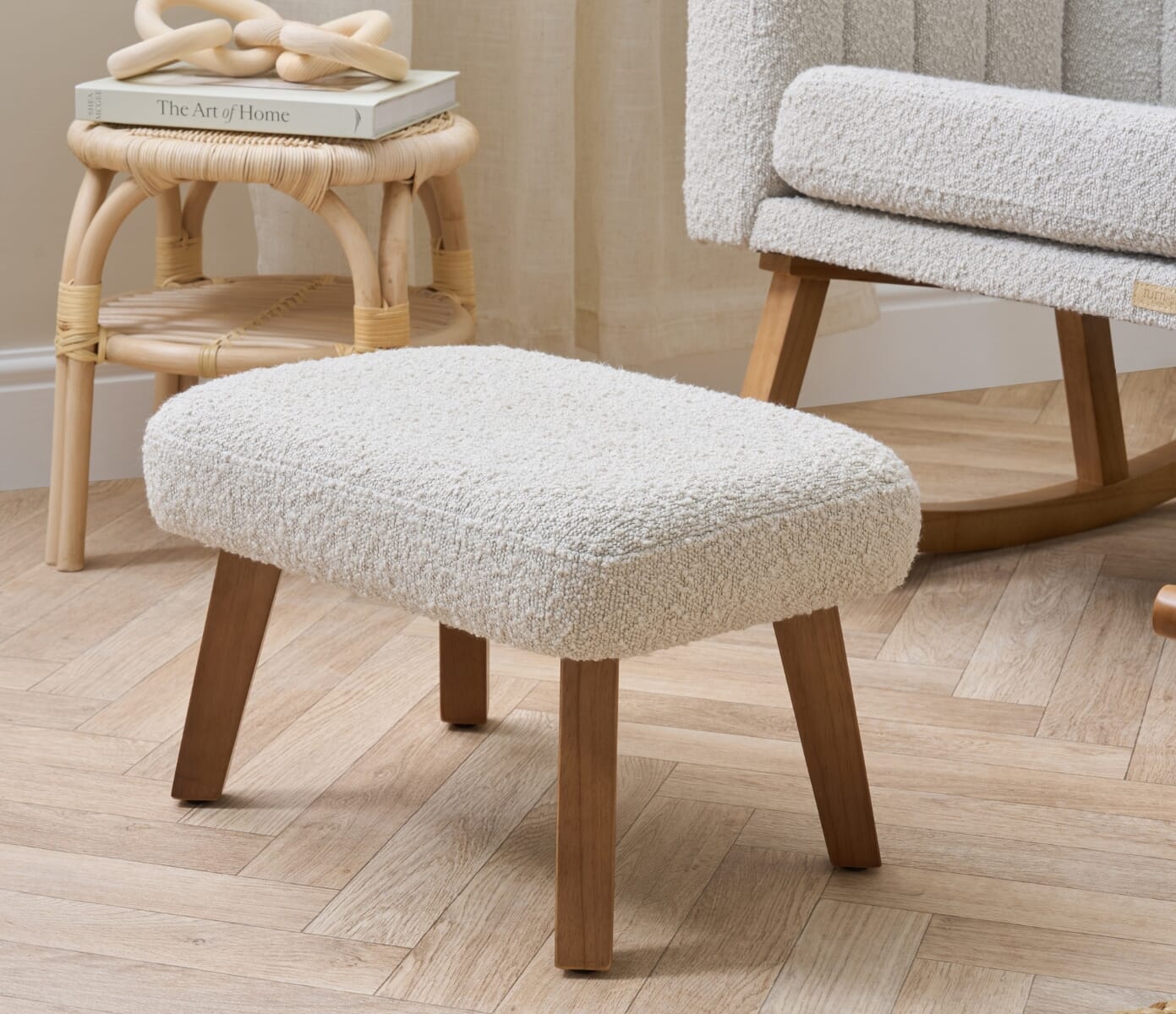 Close-up of the Jonah Luxe footstool in boucle mushroom, highlighting cushioned top, soft boucle texture and solid wooden legs
