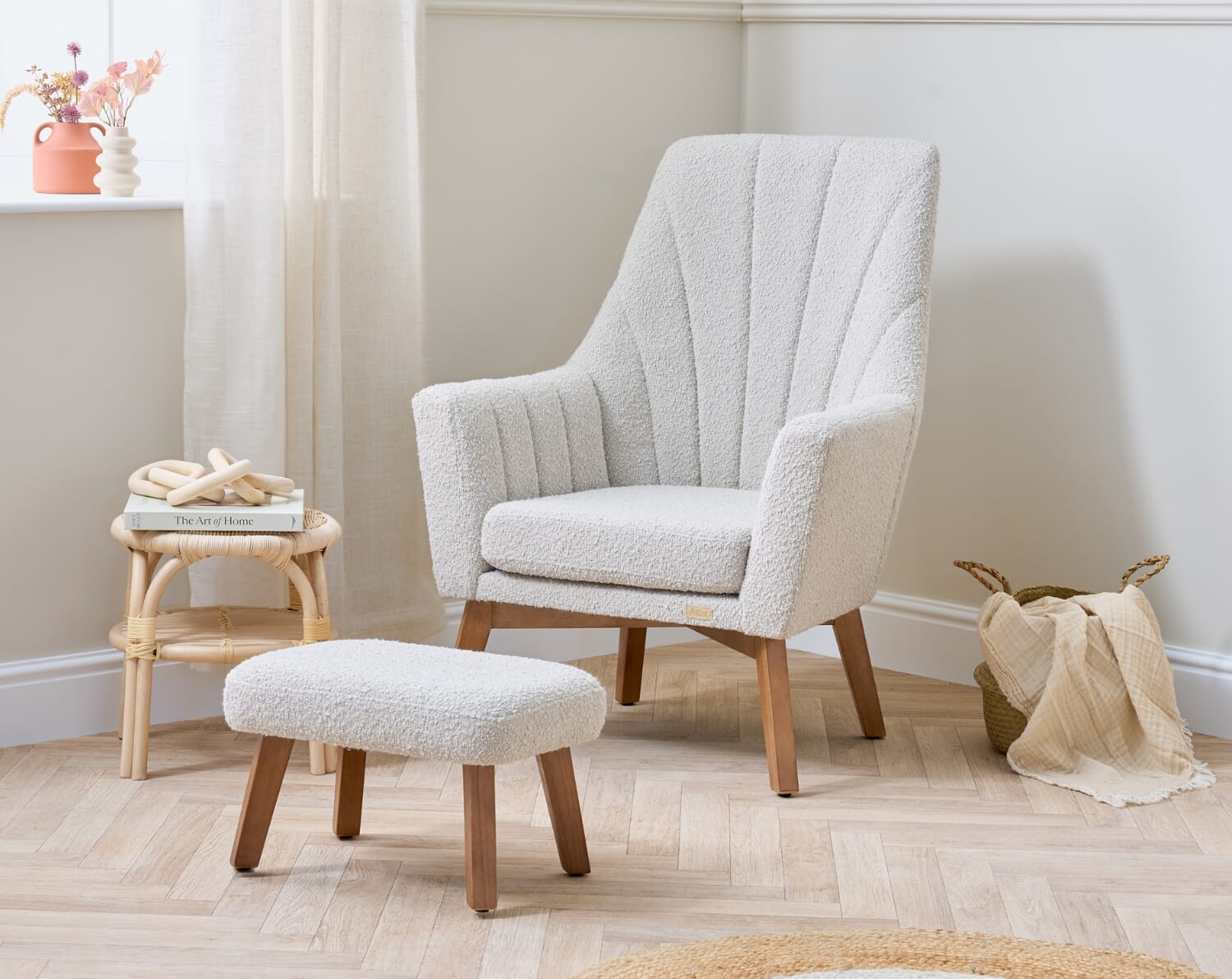 Styled nursery scene featuring the Jonah Luxe rocking chair and footstool in boucle mushroom with soft textures and natural wooden legs