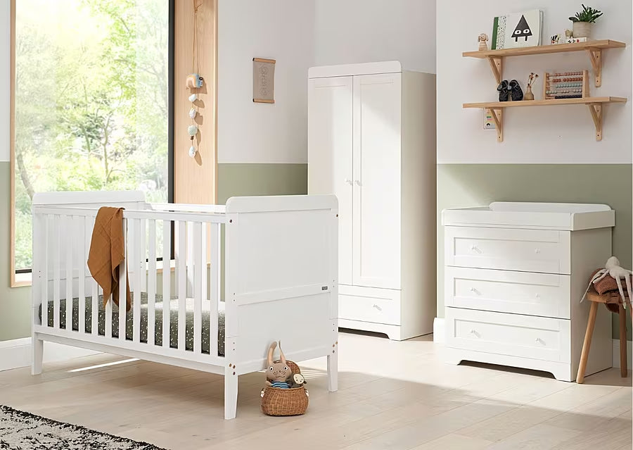 Room view of the Rio 3 piece nursery furniture set in white, featuring cot bed, wardrobe and chest changer in a calm, coordinated nursery space