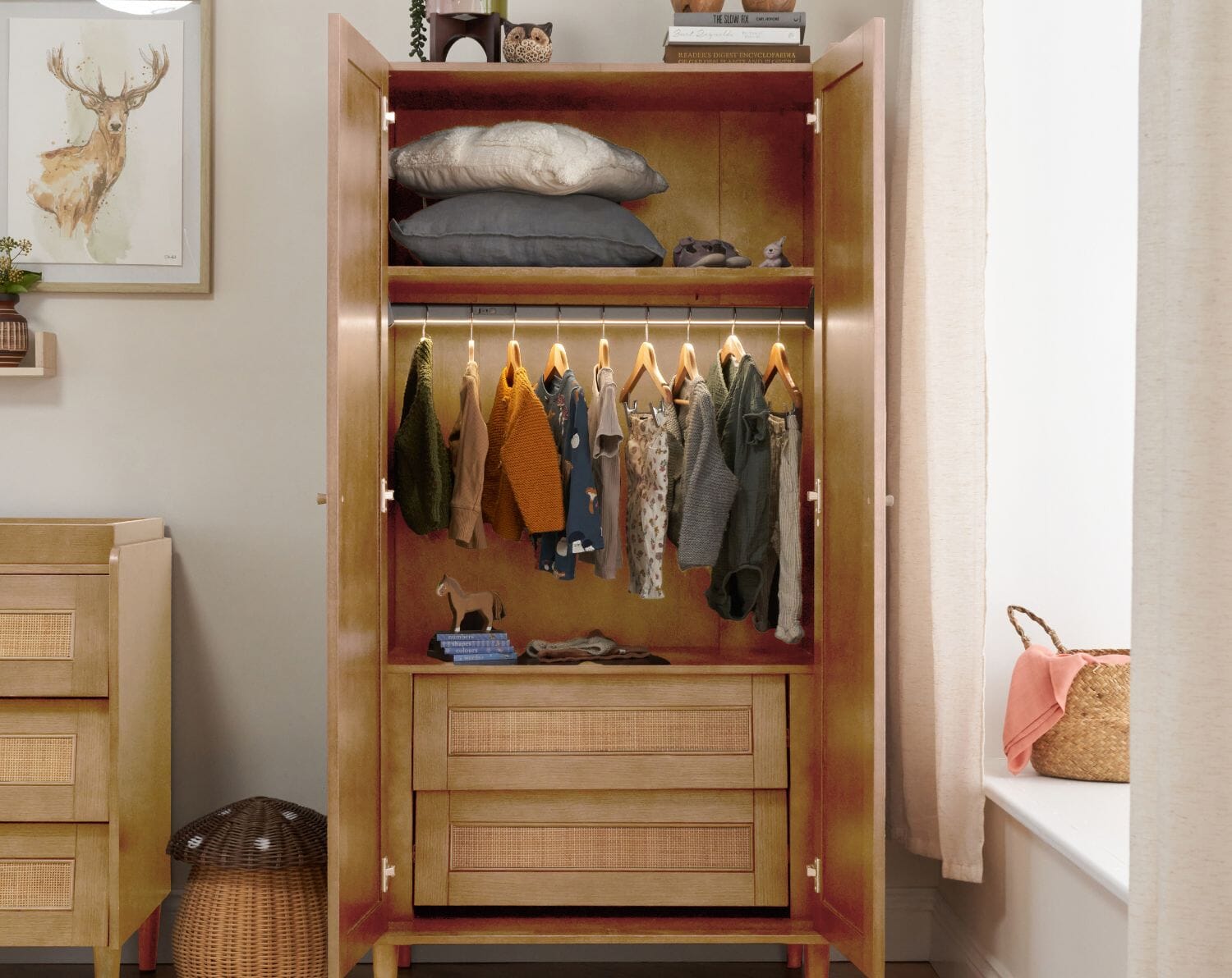 Inside view of the Japandi wardrobe in light oak, with a practical hanging rail with enhanced LED sensor lights, 2 drawers and a shelf. 