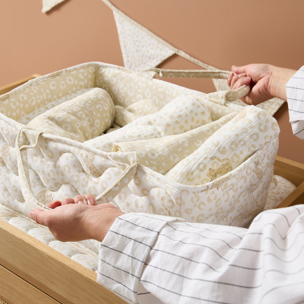Close-up of the Love Cats nappy caddy fabric in beige leopard print, highlighting quilted detailing and soft, padded finish for comfort