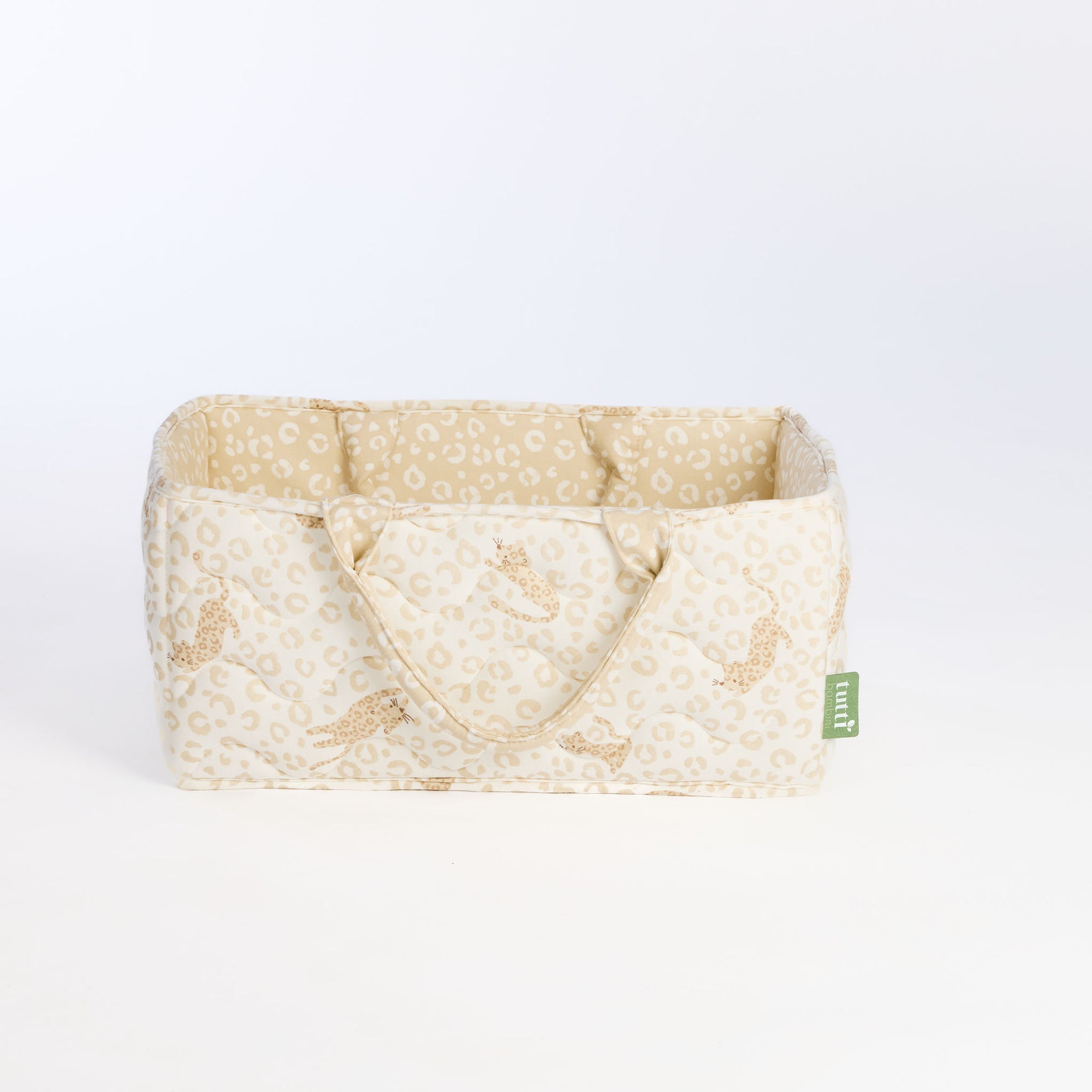 Side view of the Love Cats nappy caddy in beige leopard print, showing quilted design, structured shape, and padded carry handles