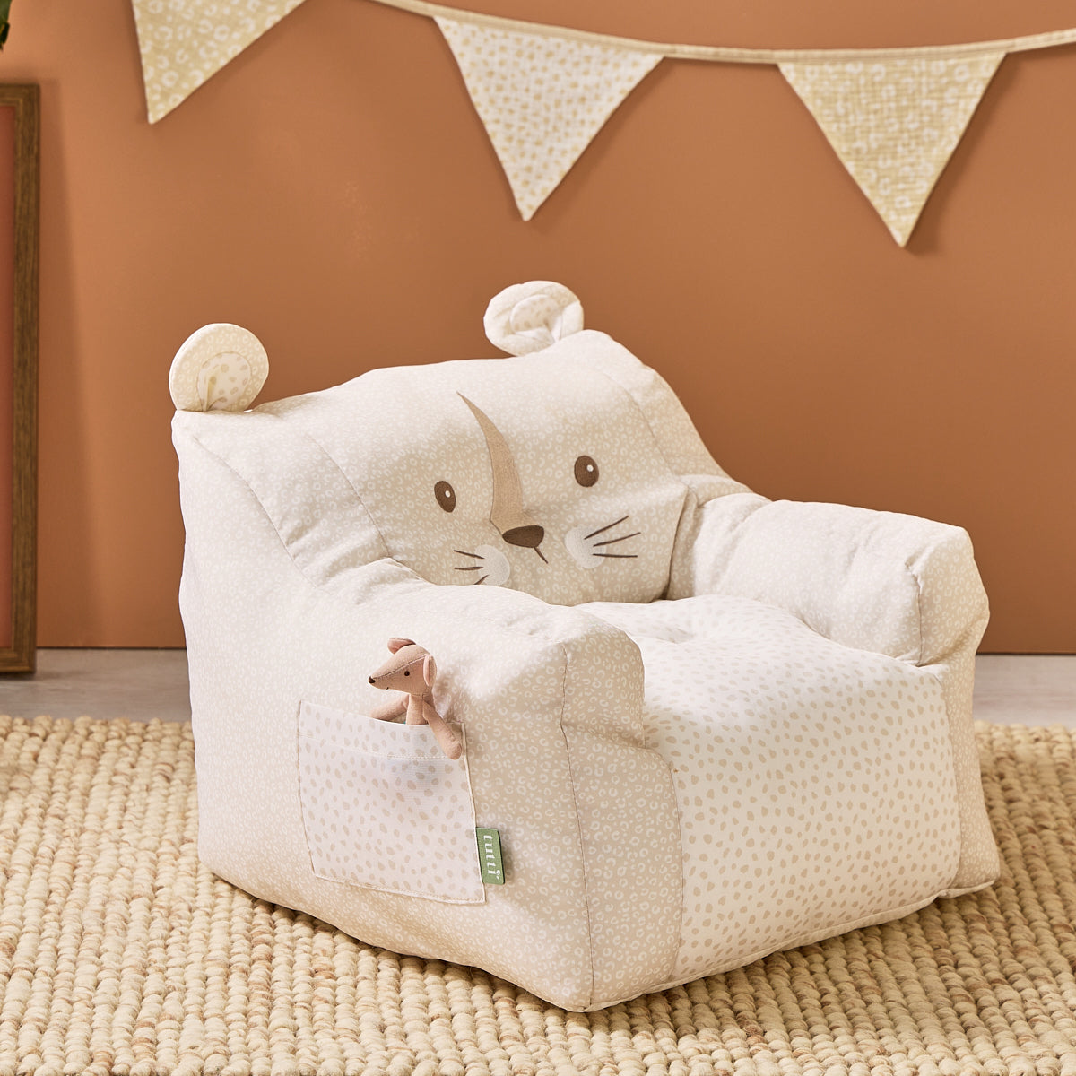 Luca Leopard beanbag chair styled in a warm-toned nursery with bunting and plush toy