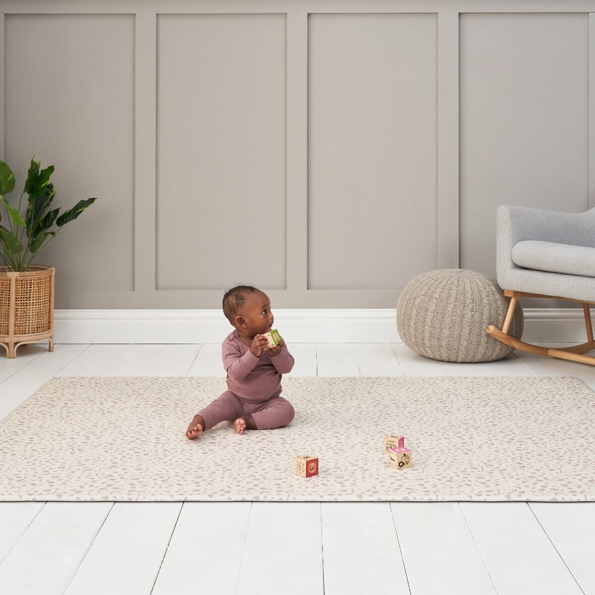 Baby plays on the Bubble Terrazzo play mat in a bright room, with soft cushioning and neutral terrazzo design creating a cosy space