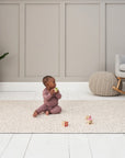 Baby plays on the Bubble Terrazzo play mat in a bright room, with soft cushioning and neutral terrazzo design creating a cosy space
