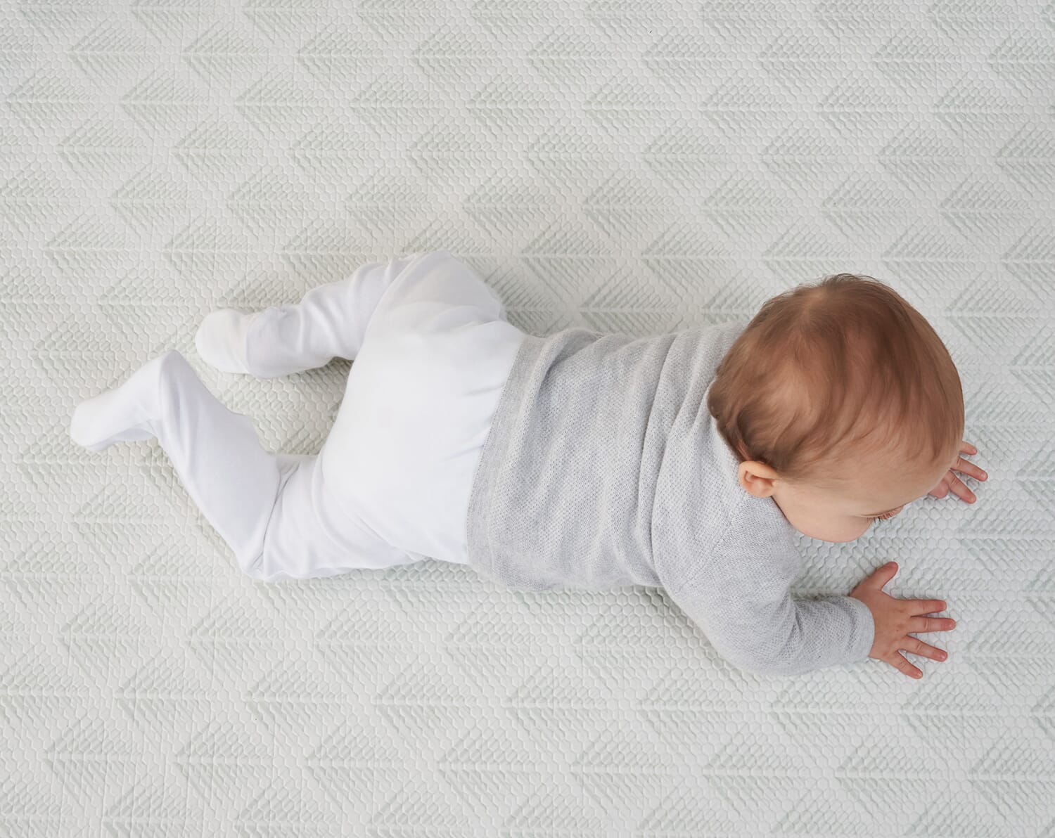 Baby crawling on the Luxury Padded XL Play Mat in fan design, showing soft textured cushioning and a calm, neutral play surface