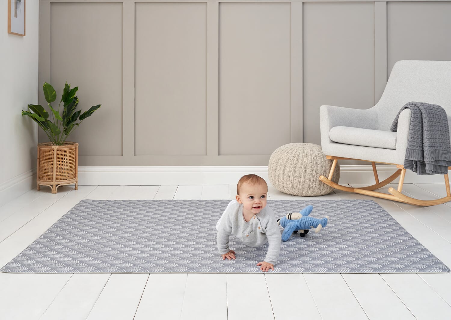 Toddler crawling on the Luxury Padded XL Play Mat in fan design in a calm nursery setting, showing its spacious, cushioned play area