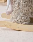 Close-up side view of Mimi the Mammoth rocking toy, focusing on smooth wooden rockers and stable base for safe indoor play