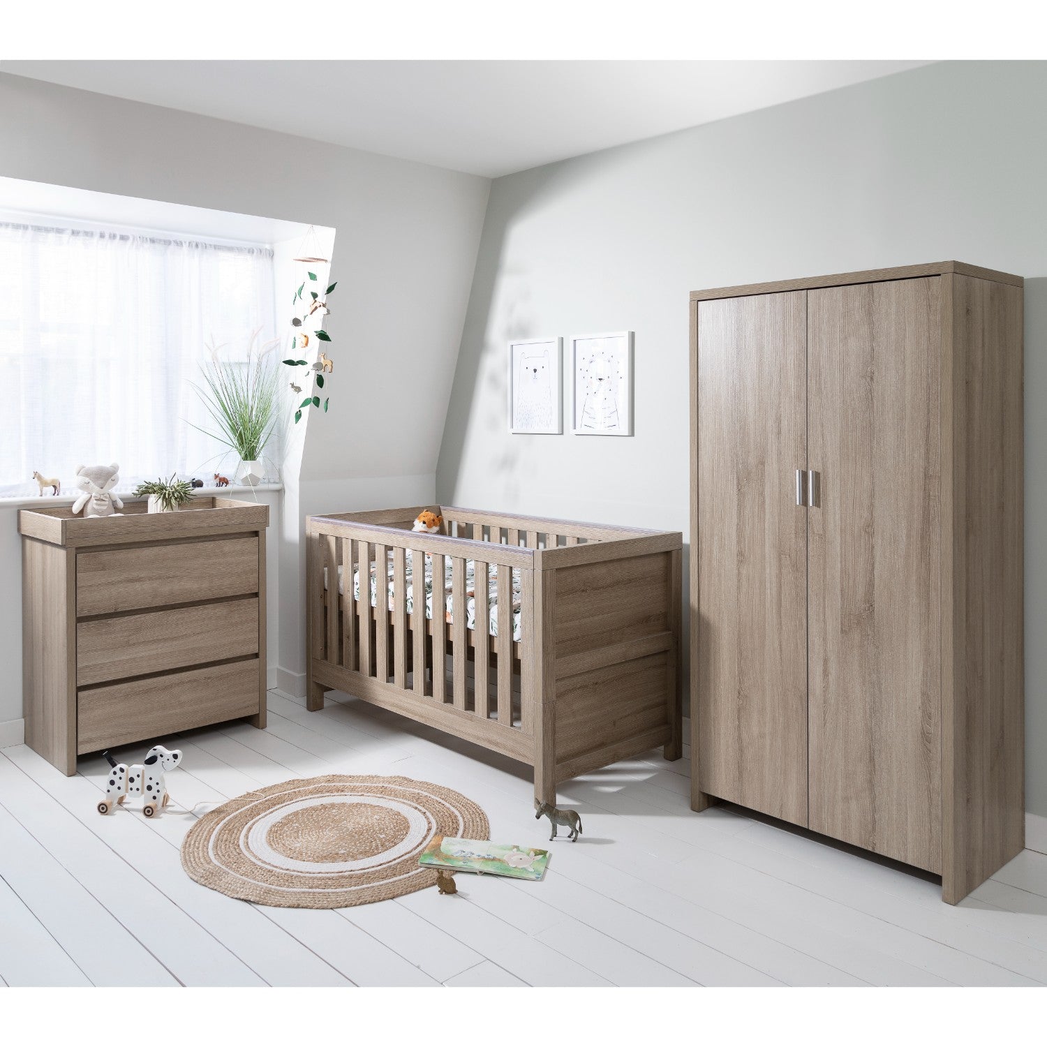 Modena oak nursery room set including cot bed, chest changer and wardrobe, styled together in a calm, neutral nursery