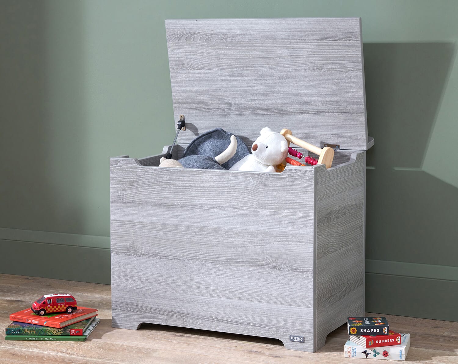 Modena toy box in grey ash with lid open, highlighting spacious interior storage for toys, books, and nursery essentials
