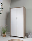 Modena wardrobe in white and oak, closed and placed in a minimalist children's bedroom, offering stylish and practical storage.