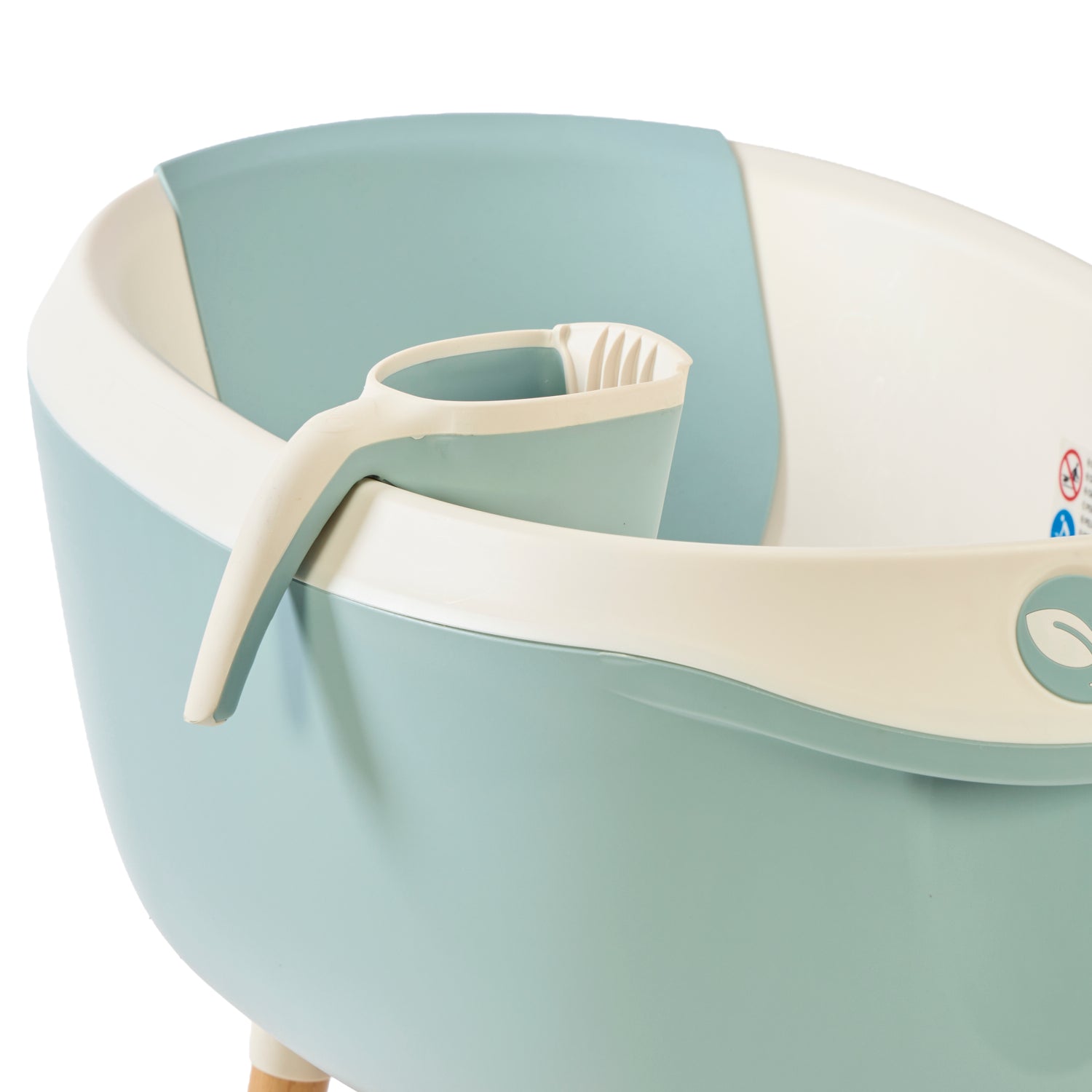 Close-up of the Nati Bath Jug in ocean attached to the matching bath rim, showing ergonomic handle and rinse spout.