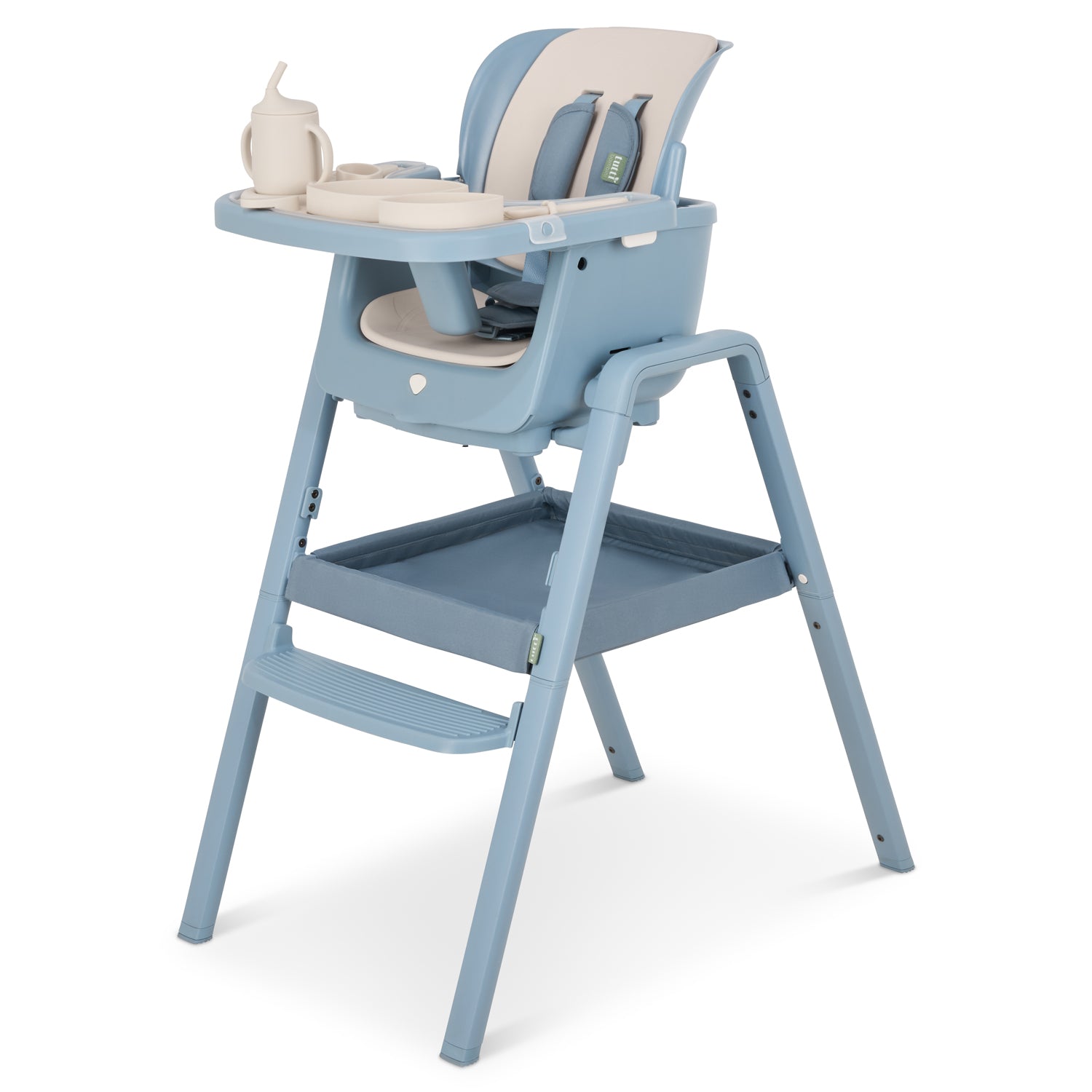 Angled cutout view of the Nova Maison highchair in rusk with full accessory pack fitted, showing tray, harness, footrest and storage basket.