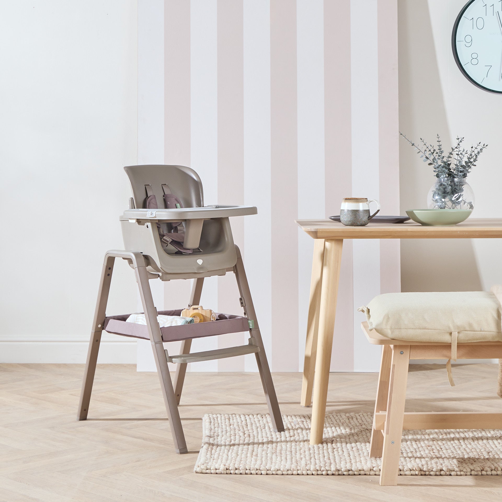 Nova Maison highchair in truffle styled in a calm kitchen setting beside wooden dining table and soft neutral décor.
