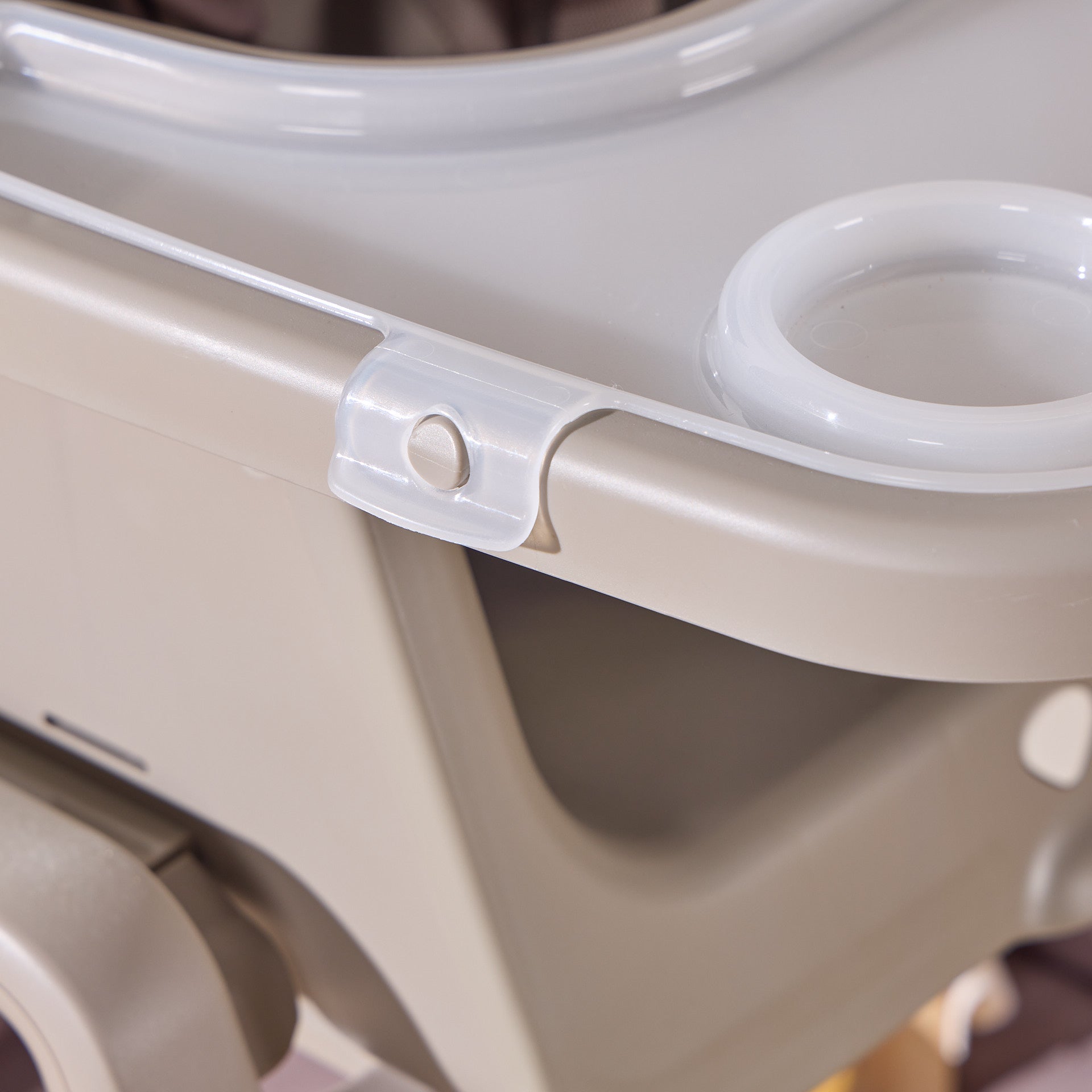 Close-up of Nova Maison highchair in truffle showing secure tray fastening clip for safe and stable mealtimes.