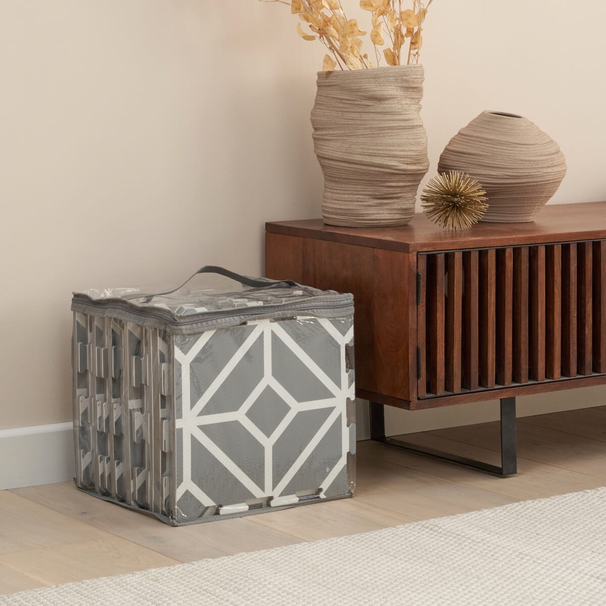 Grey geometric puzzle playmat neatly stored in its zip bag, showing compact, easy-to-carry panels designed for simple home storage