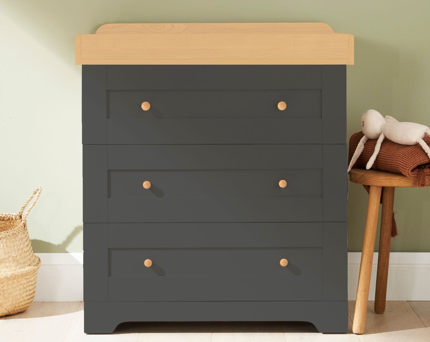 Close-up of the Rio chest changer in slate grey and honey oak, showing smooth drawer fronts, rounded handles and the integrated changing top