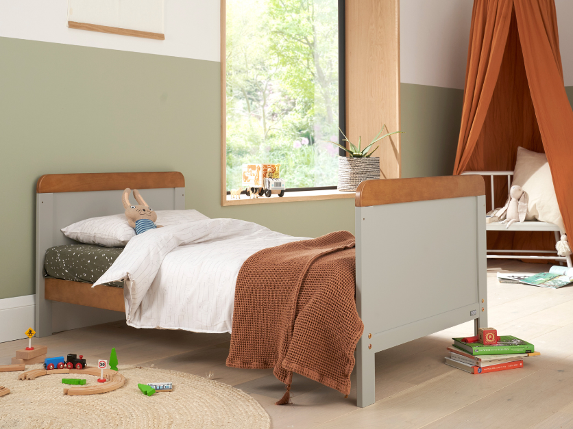 rio cot bed honey oak dove grey transformed into a toddler bed shown in a bright nursery