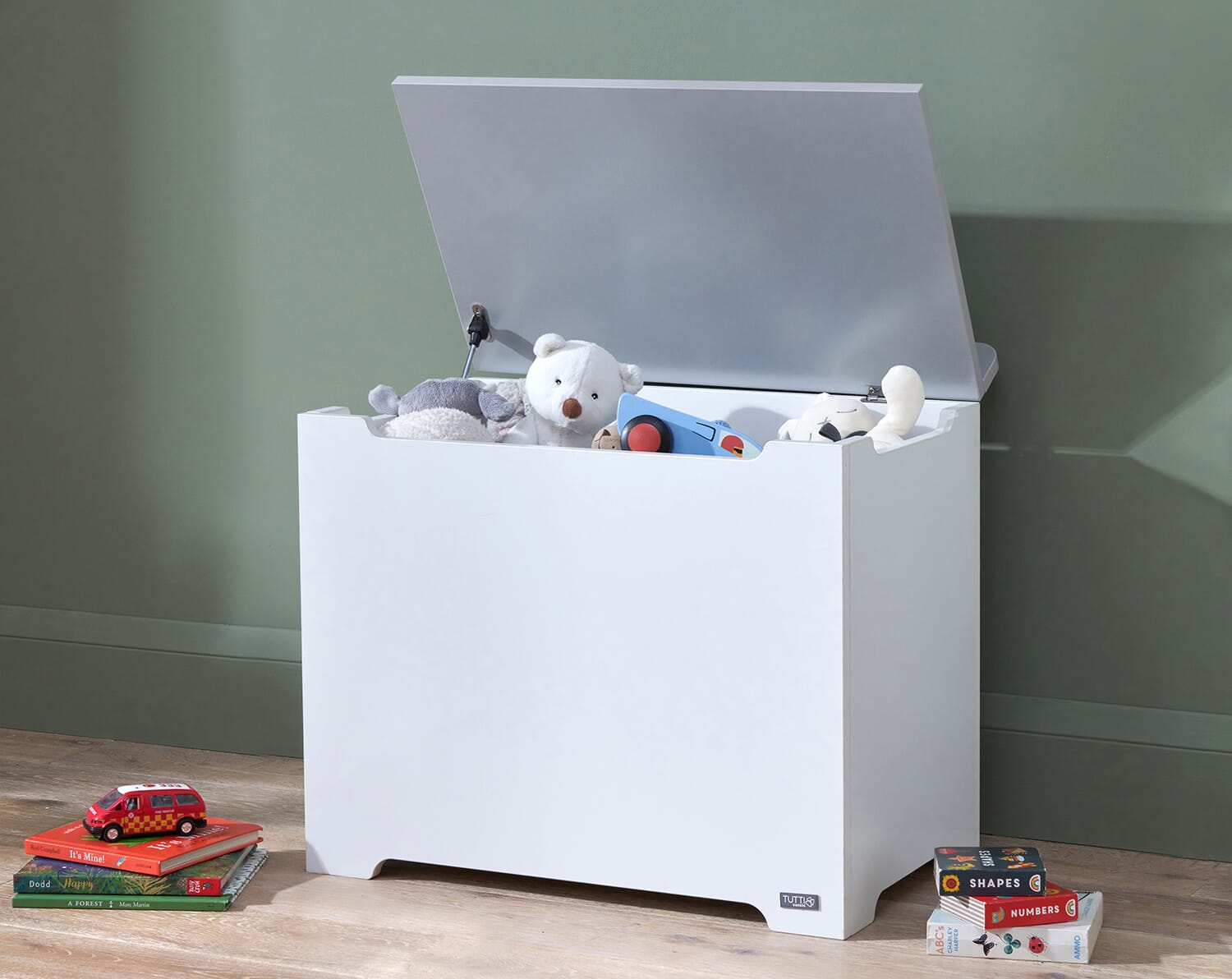 Open toy box in white and dove grey showing spacious interior filled with soft toys, highlighting smooth edges and safe soft-close hinge