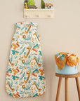 Run Wild baby sleep bag in safari print displayed hanging in a nursery, adding playful colour and practical sleep style