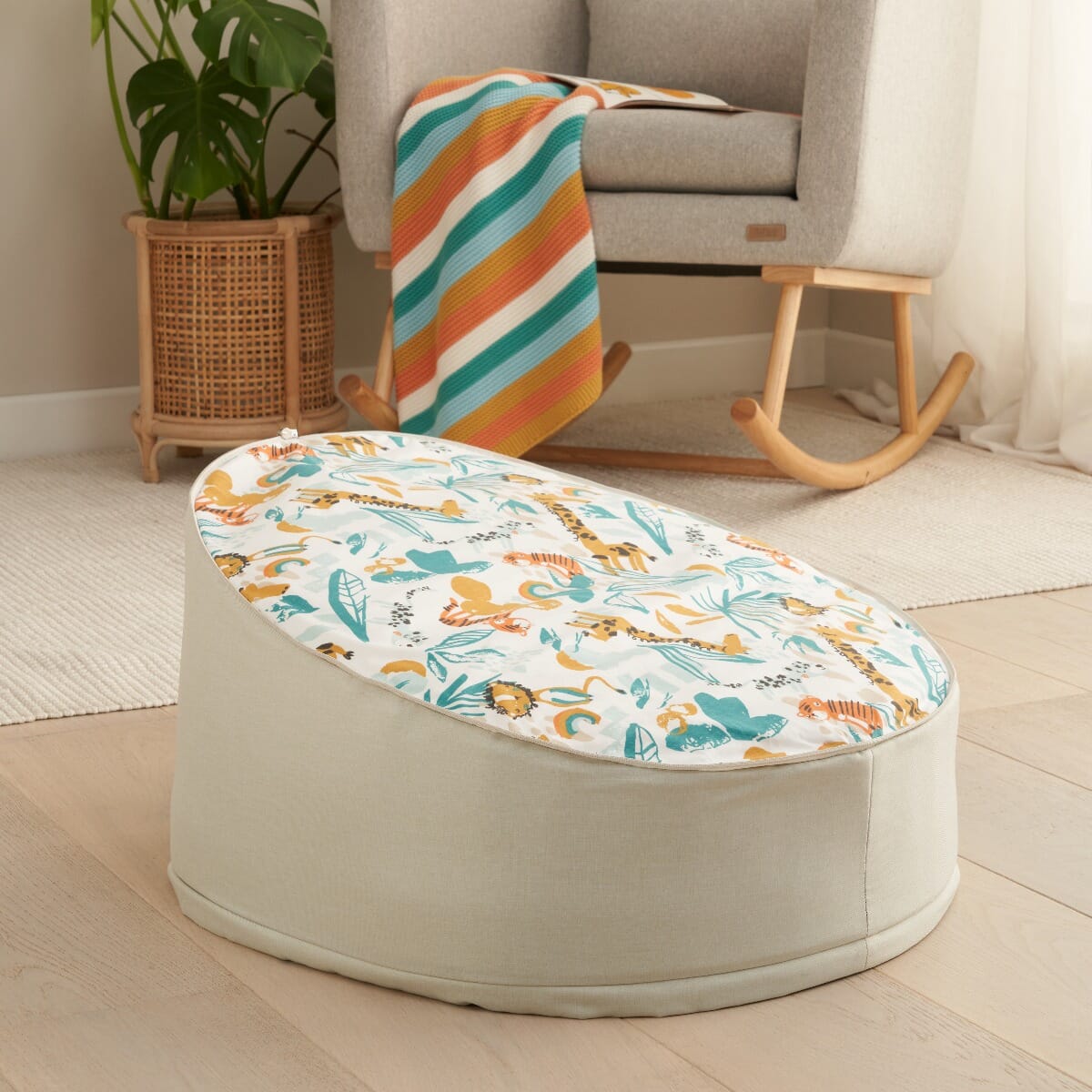 Lifestyle image of the Run Wild baby beanbag styled in a calm nursery setting, paired with a rocking chair and soft furnishings