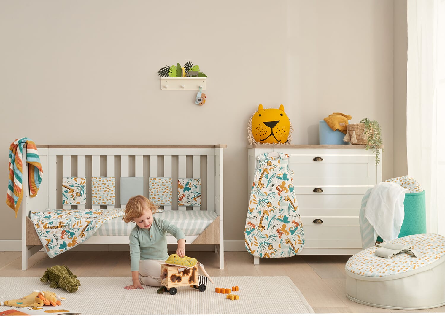 Nursery styled with the Run Wild collection, featuring coordinating bedding, sleep bag and comforter in playful safari-inspired prints