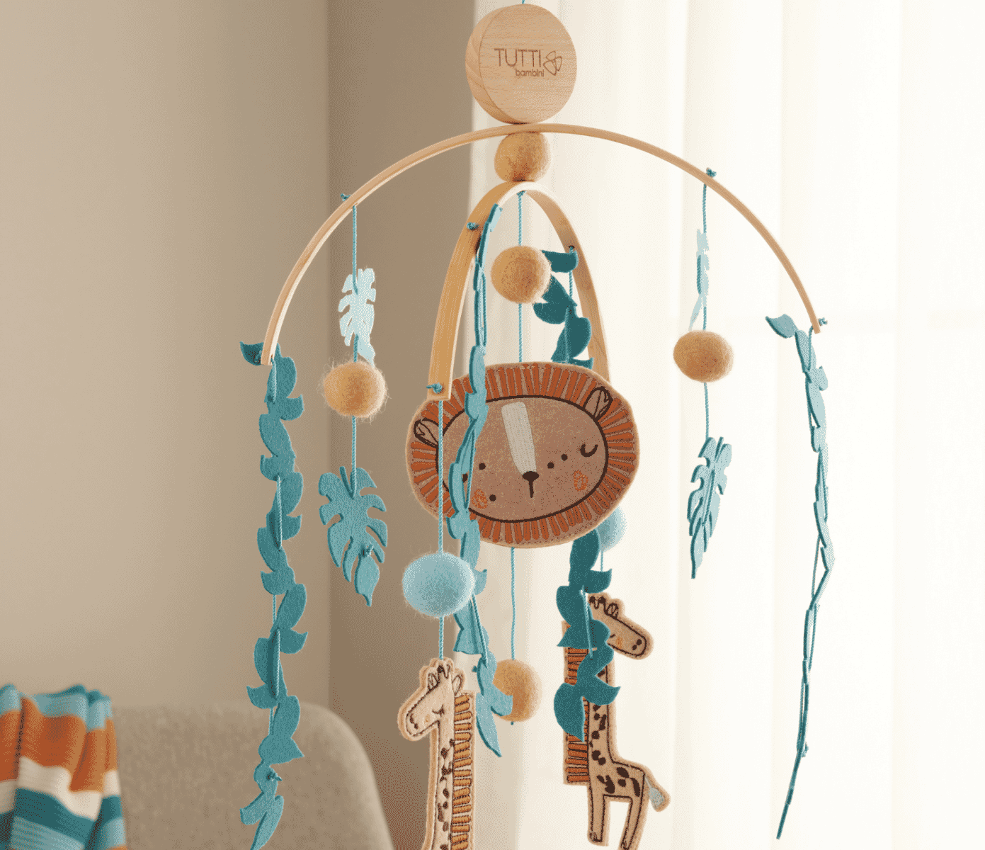 run wild decor bundle featuring mobile nursery decor in a nursery setting with blanket drapped over chair