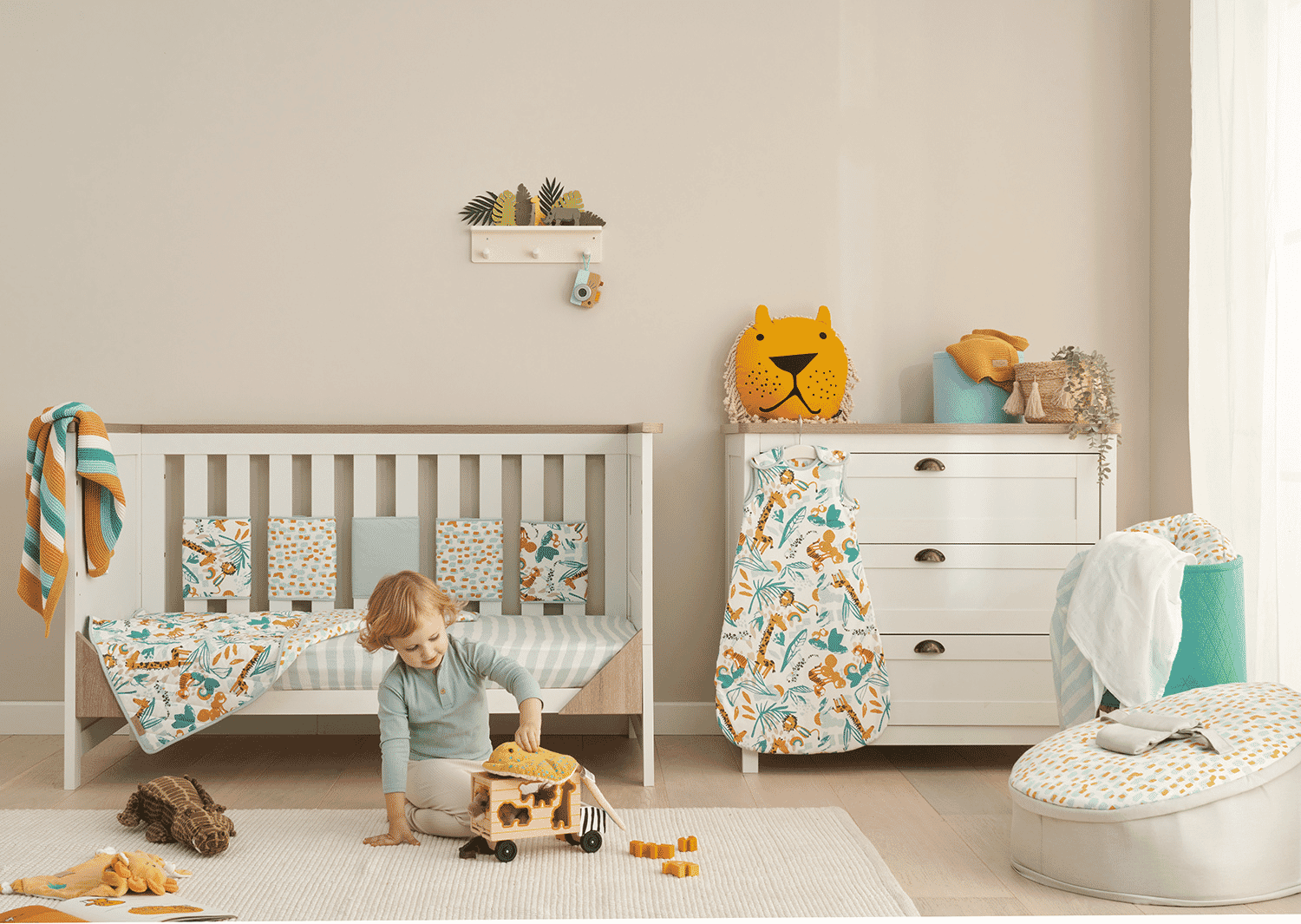 Styled nursery scene featuring the Run Wild collection, with cot bedding, accessories and storage creating a playful, coordinated jungle theme