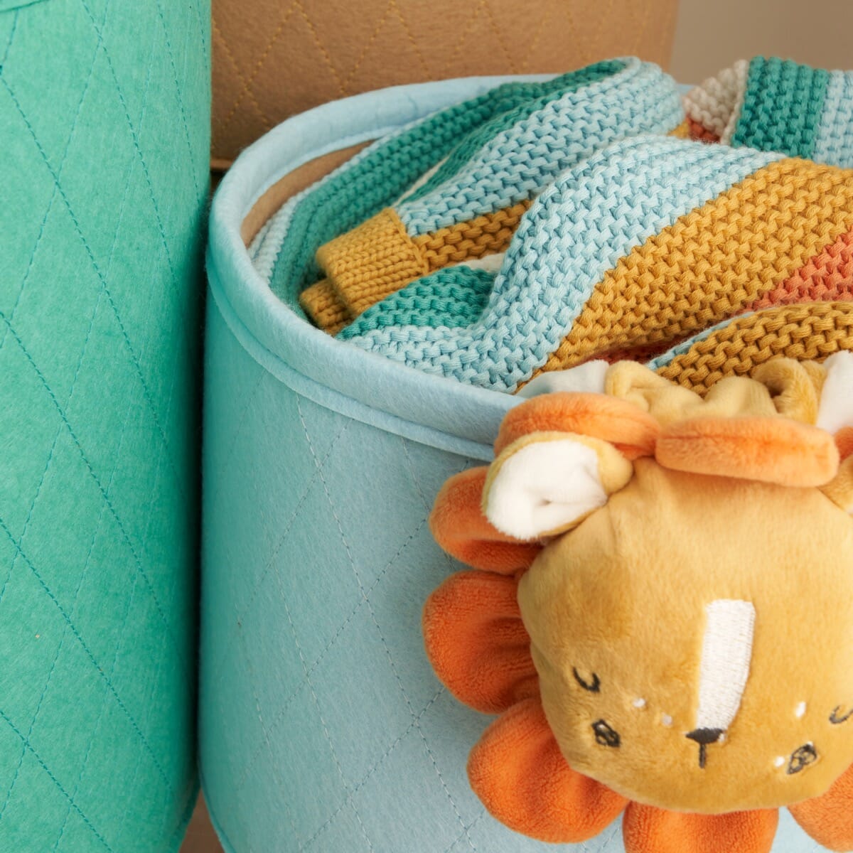 Close-up of the Run Wild storage basket in quilted fabric, highlighting stitched detailing and soft felt finish for gentle nursery storage