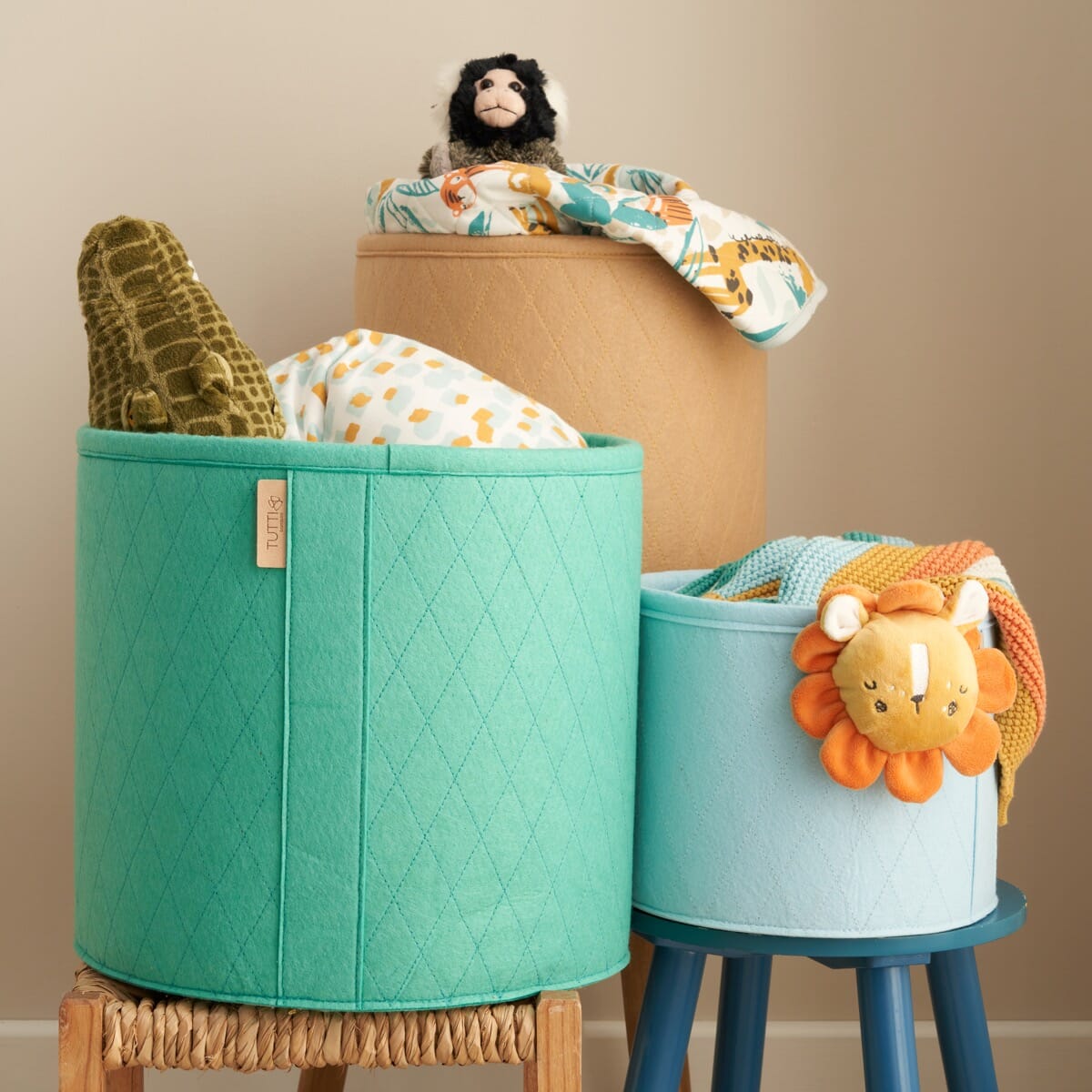 Run Wild storage baskets filled with soft toys and blankets, styled to show practical nursery organisation with a playful, design-led feel