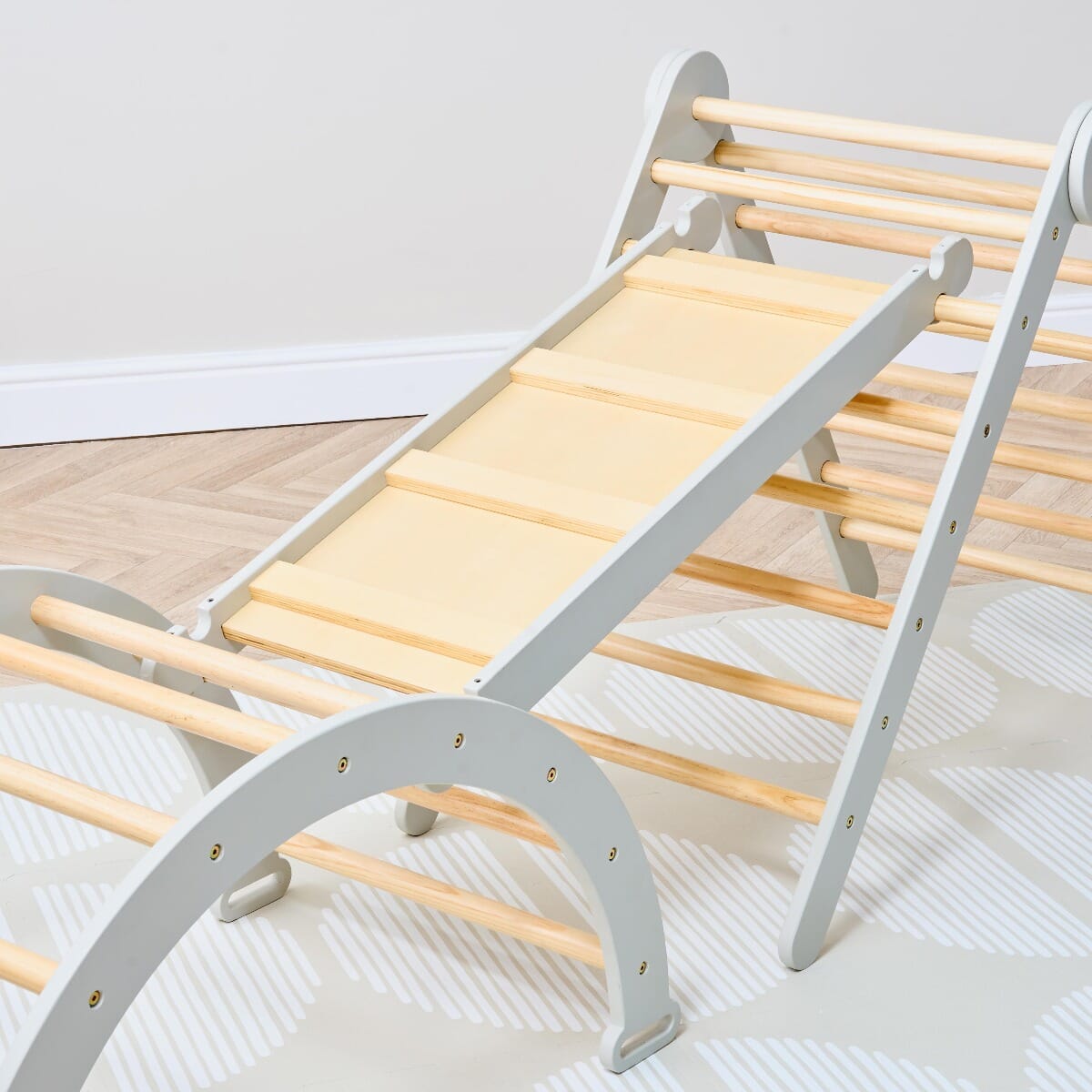Overhead close-up of the Scala Montessori Pikler climbing frame in mushroom finish, showing sturdy ladder ramp for safe climbing