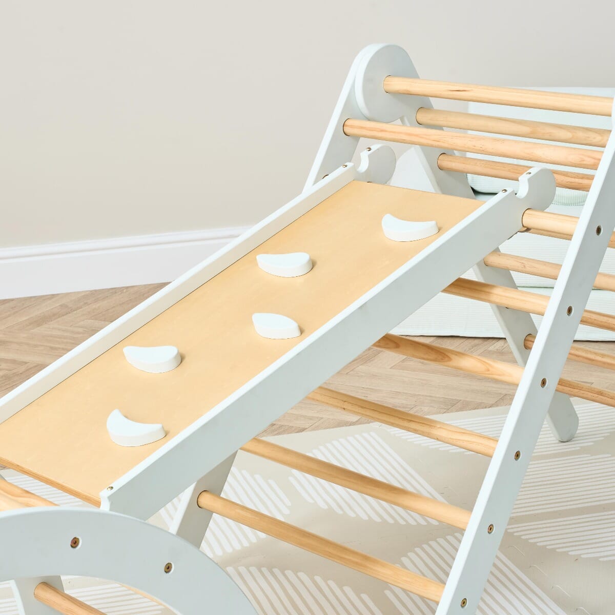 Ladder view of the Scala Montessori Pikler climbing frame in sea mist, showing stable rungs for safe climbing and gross motor play
