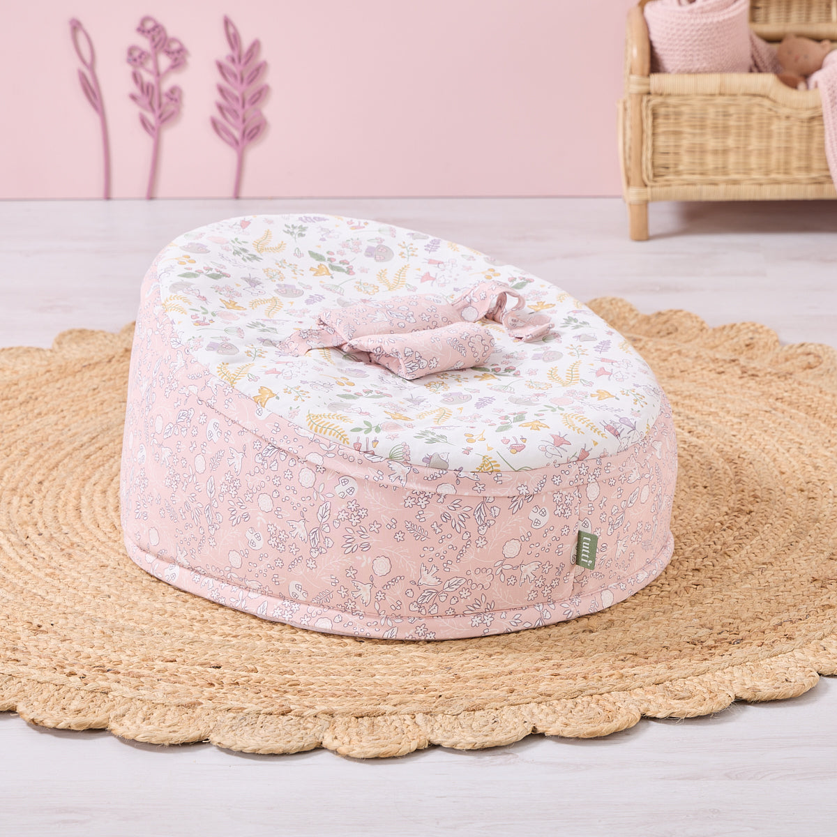 Tiny Tails beanbag in pastel pink and white woodland print, styled in a cosy nursery on a woven rug for soft, supportive comfort