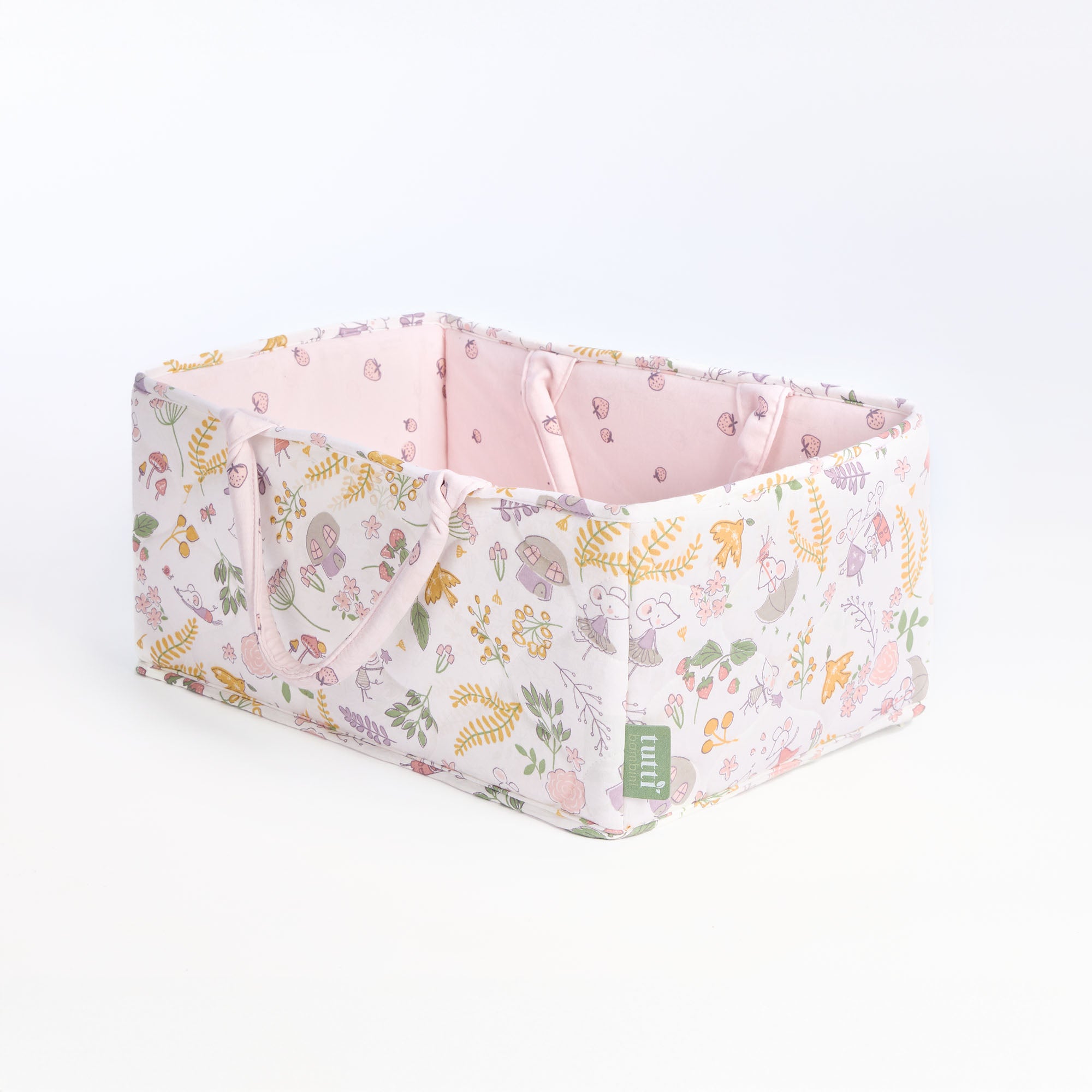 Angled cutout of the Tiny Tails nappy caddy in pink floral woodland print, highlighting quilted detail and spacious storage design