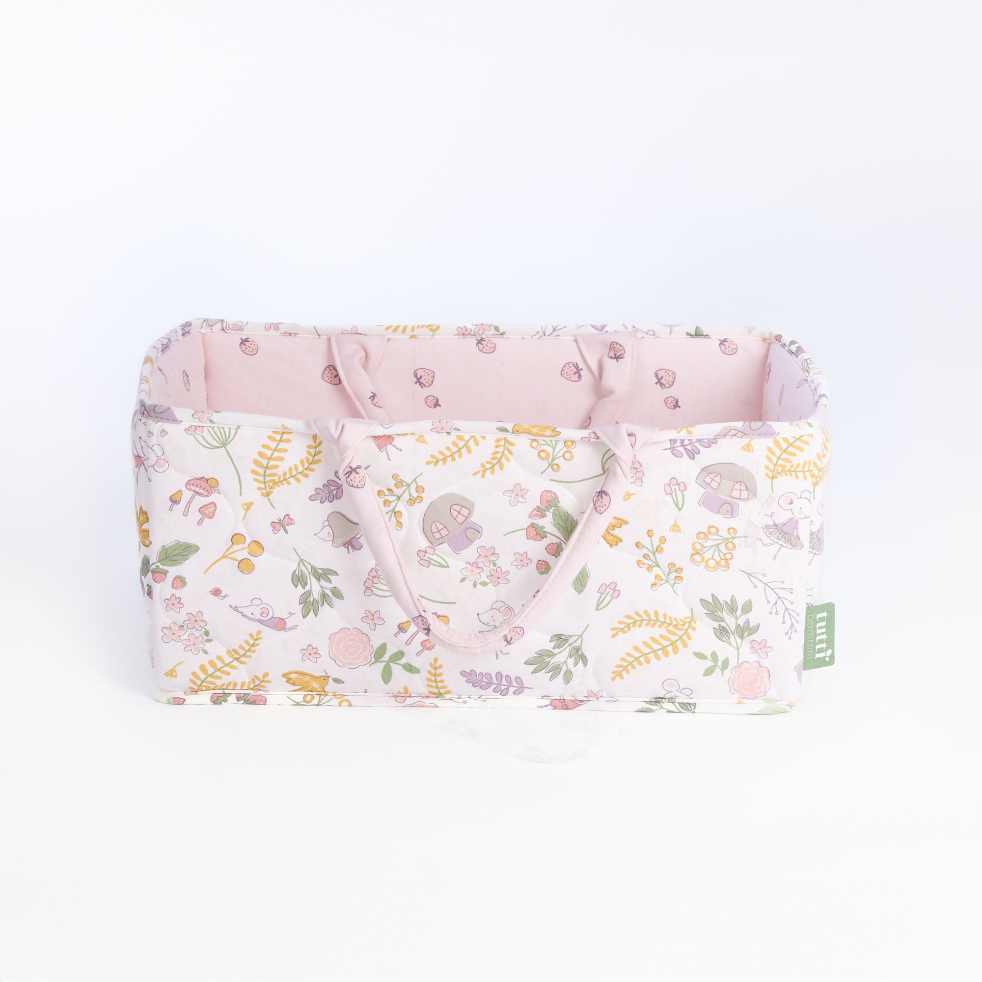 Side view of the Tiny Tails nappy caddy in pink woodland pattern, featuring soft padded handles and coordinating blush interior