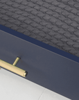 Close-up of the Tivoli chest changer drawer in navy showing textured gold handle and neatly folded knitted blanket inside