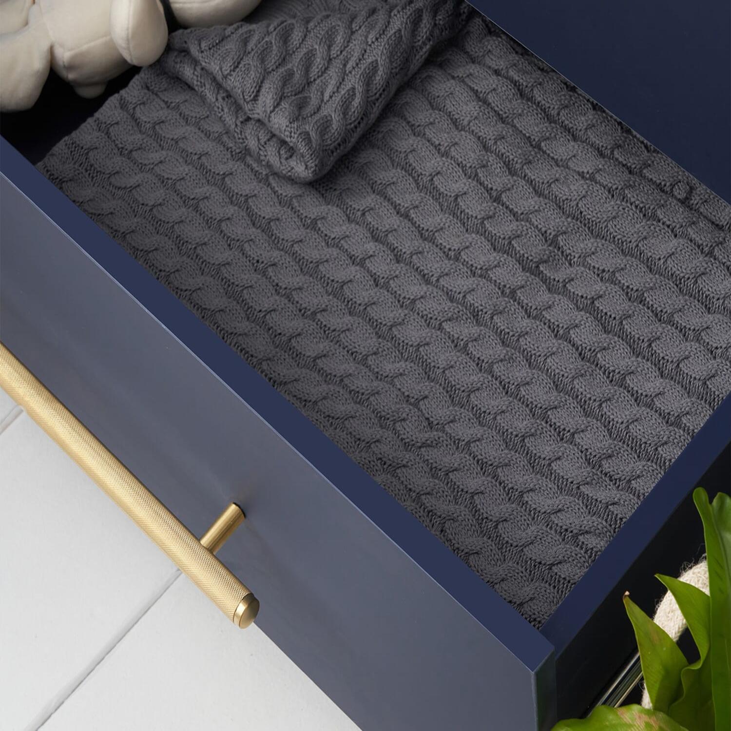 Close-up view of the Tivoli chest changer in navy with drawer open, highlighting spacious storage and smooth brass handle detail