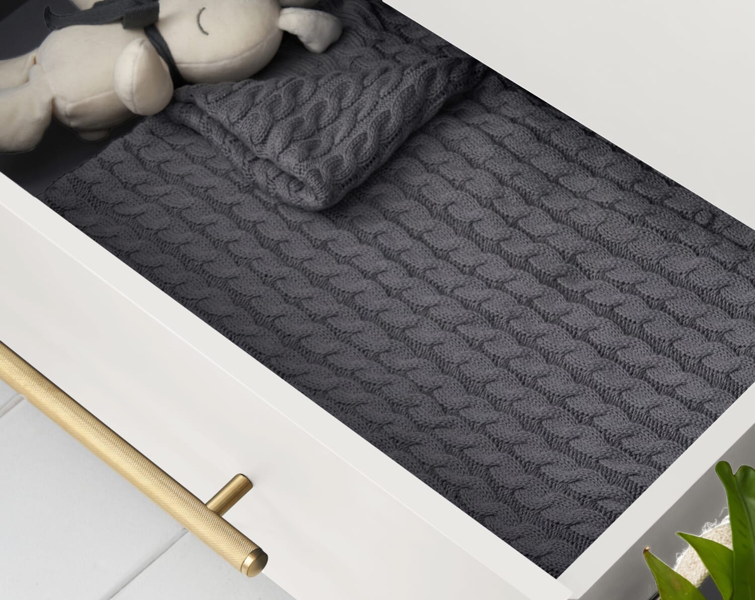 Close-up of the Tivoli chest changer in white, highlighting the textured gold handle and soft-close drawer detailing