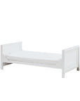 Angled view of the Tivoli cot bed in white converted into a toddler bed, showing low-level design for safe, independent sleep