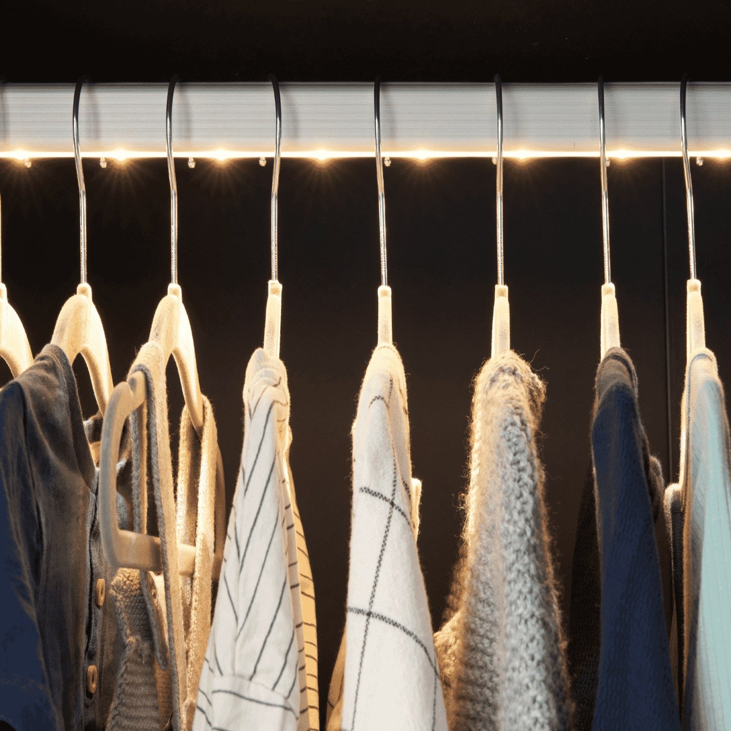 Close-up of the Tivoli wardrobe hanging rail in navy, featuring integrated LED lighting to clearly illuminate children’s clothing