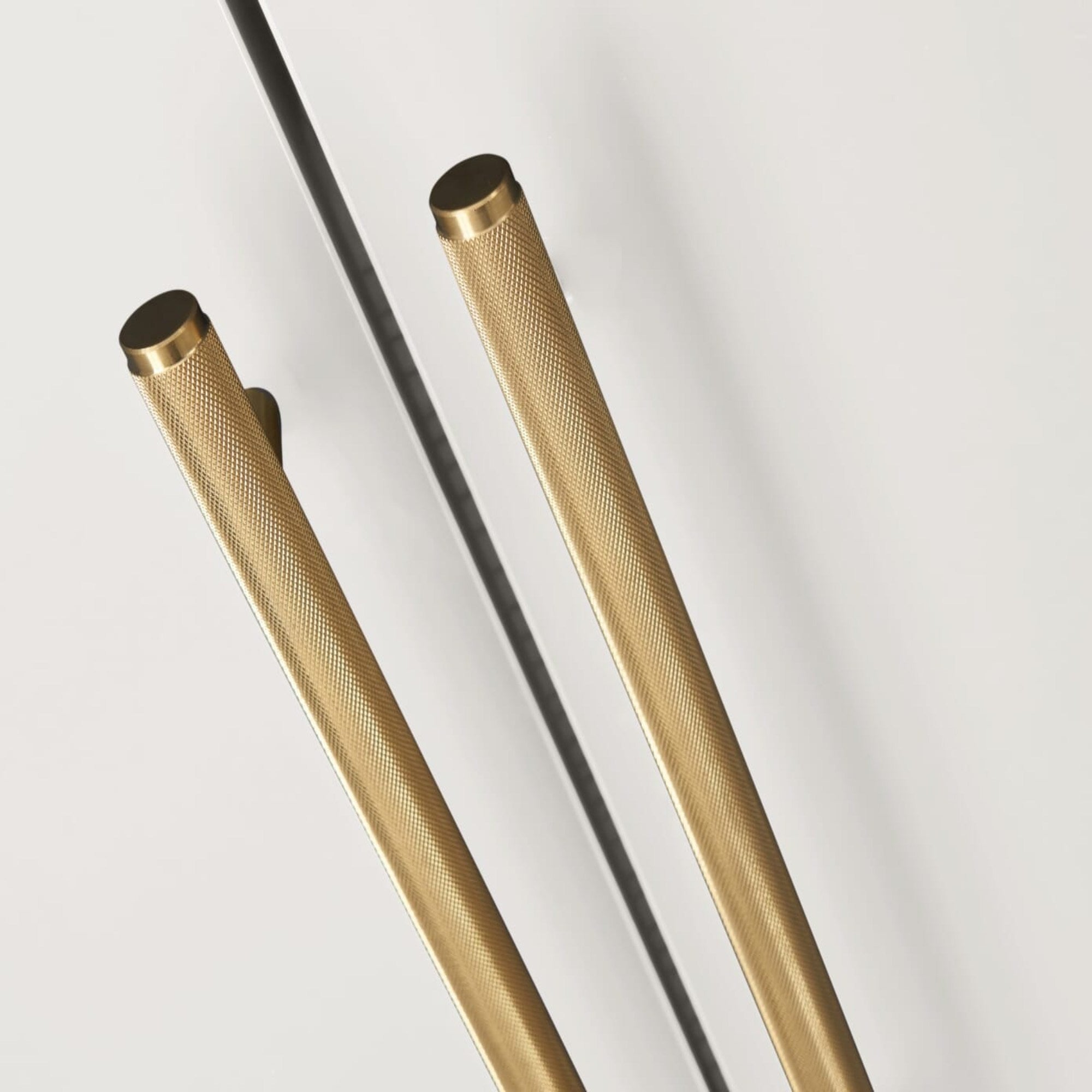 Close-up of the Tivoli wardrobe in white, highlighting knurled brass handles and smooth painted finish for a refined, modern look