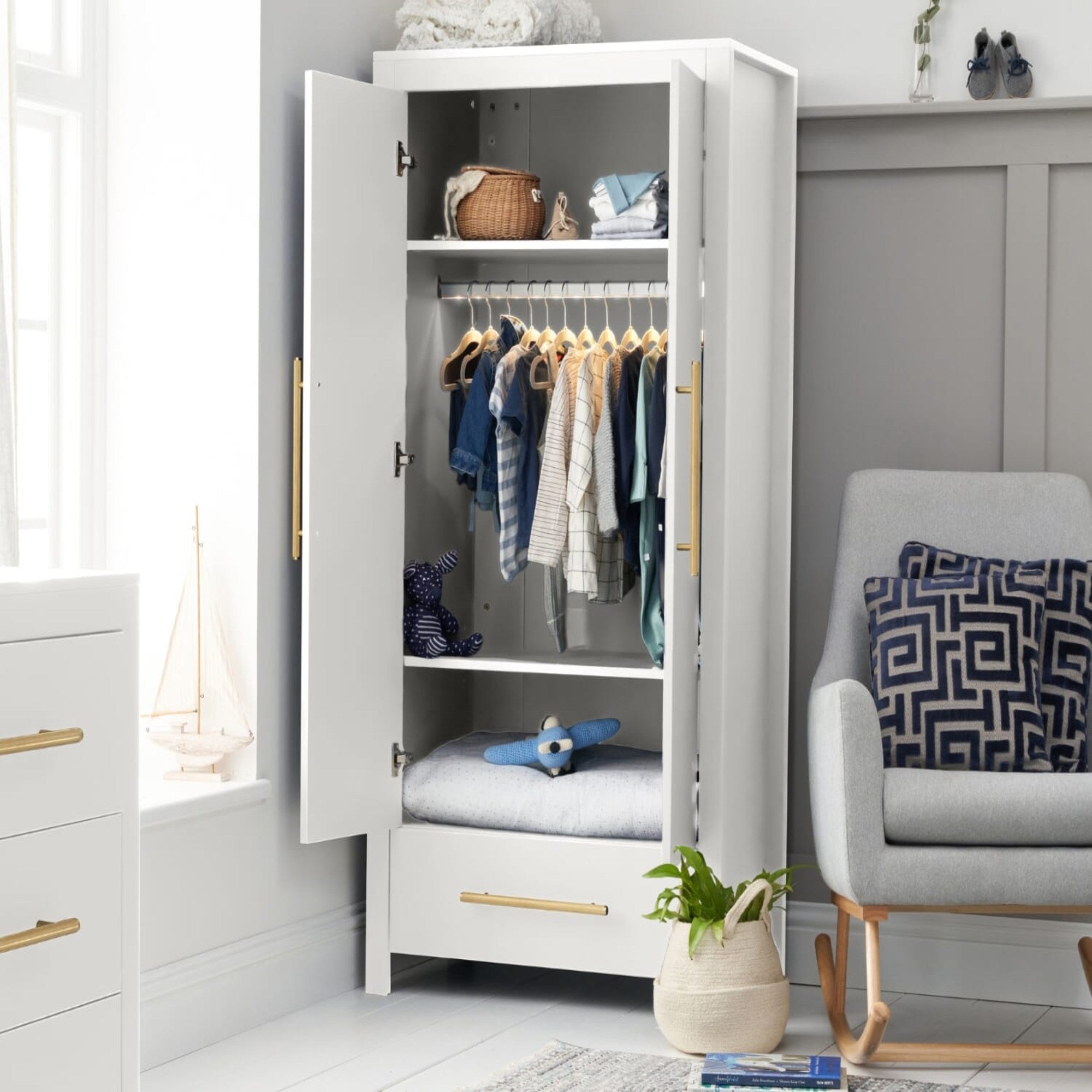 Lifestyle view of the Tivoli wardrobe in white with doors open, showing internal shelving, hanging rail and soft integrated lighting