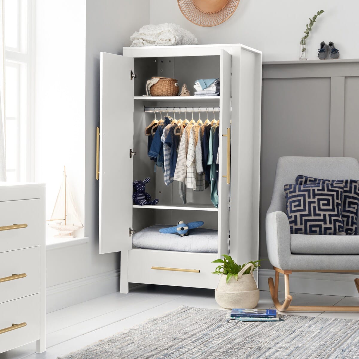 Tivoli wardrobe in white with gold handles and open doors, showcasing ample storage in a modern, chic nursery room.