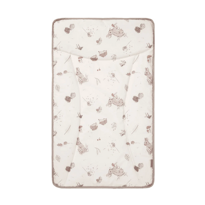 A beige changing mat with a woodland animal pattern including small illustrations of rabbits and leaves.