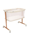 Beige baby crib with wheels on a white background